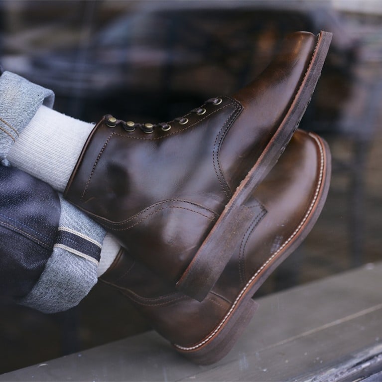 Men's casual boots shown through a window